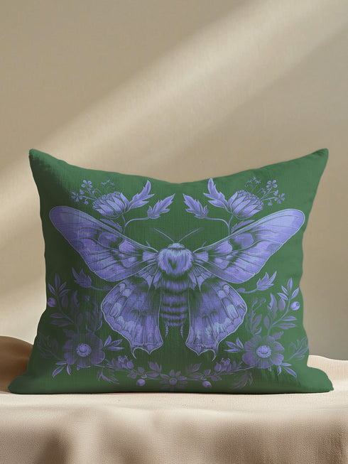 A decorative pillow cover featuring an intricate Luna moth illustration in lavender purple on an emerald green background, adorned with symmetrical botanical details and florals in a vintage naturalist style.